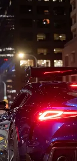 Sports car with glowing taillights on a city street at night.