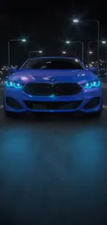 Sleek car with neon blue lights driving at night.