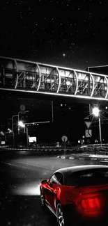 Red sports car driving under a night sky with stars and city lights.