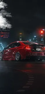 Red car in a neon-lit city street at night.