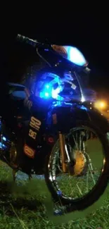 Motorcycle glowing in blue lights at night.