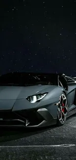 Sleek sports car at night with starry sky backdrop.