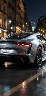 Sleek silver sports car on wet city street at night.