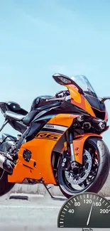 Orange sports motorcycle against clear sky with speedometer overlay.