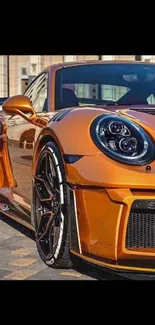 Orange sports car parked in urban scene, close-up view.