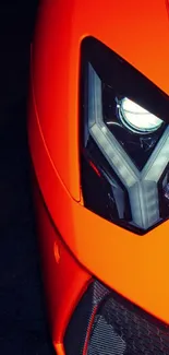 Close-up of sleek orange sports car with modern design elements.