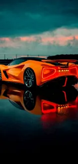 Orange sports car reflecting on wet pavement at sunset.