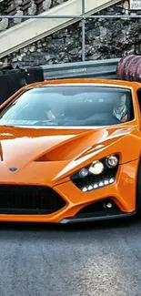 Orange sports car on a racetrack, showcasing luxury.