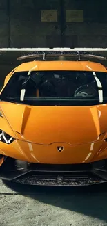 Dynamic orange supercar in an industrial setting captures speed and luxury.