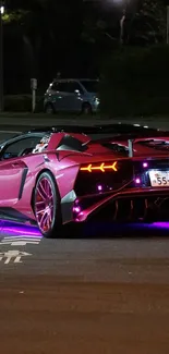 Vibrant pink sports car with neon glow at night.