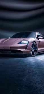 Sleek pink sports car with headlights on, in a moody background.