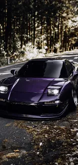 Sleek purple sports car on a forest road in autumn.