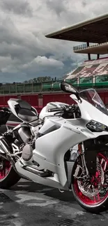 White racing motorcycle on a track with dynamic clouds.