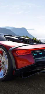 Red sports car on scenic coastal road with ocean view.