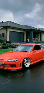 Sleek red sports car parked on wet street.