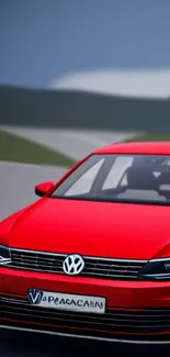 Sleek red car on a scenic road with blurred background.