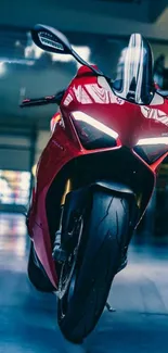 Red motorcycle in a stylish garage setting, frontal view.