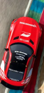 Top view of a red race car on a race track.