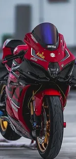 Sleek red racing motorcycle parked indoors.