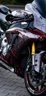 Sleek red sportbike with dynamic design on pavement.