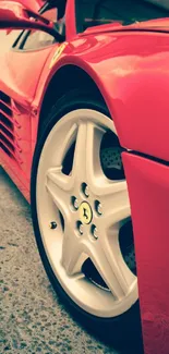 Close-up of a sleek red sports car wheel.