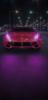 Red sports car speeding under city lights at night with purple glow on the road.