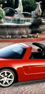 Red convertible sports car wallpaper with scenic background.