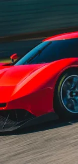 Red sports car speeding on a track, showcasing sleek design.