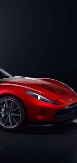 Red sports car on dark background, sleek design.