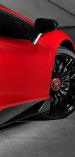 Close-up of sleek red sports car wheel design.