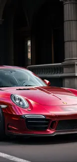 Sleek red sports car in urban setting.