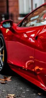 Mobile wallpaper of a red sports car parked on a street.