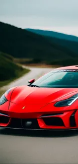 Sleek red sports car on a scenic road.