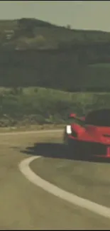 Red sports car driving on a scenic winding road.