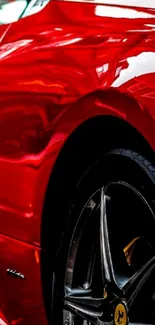 Red sports car with shiny finish in vertical wallpaper.