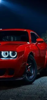 Sleek red sports car against a night backdrop.