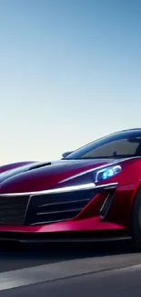 Sleek red sports car on highway with city skyline in the background.