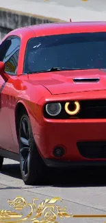 Red sports car with glowing headlights on the road.