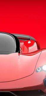 Sleek red sports car on vibrant background.