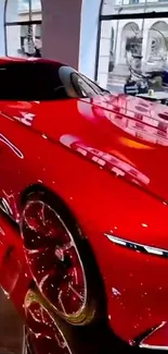 Sleek red sports car in a showroom.