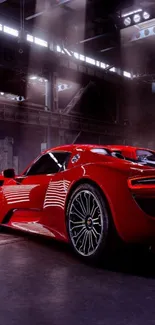 Sleek red sports car in an industrial setting.