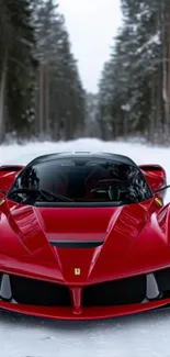 Sleek red sports car in a winter forest setting.