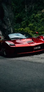 Sleek red sports car on a winding mountain road.