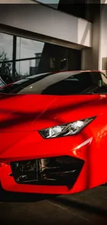 Dynamic red sports car in a showroom setting.