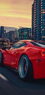 Red sports car driving through city at sunset.