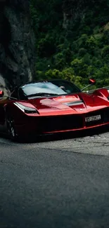 Sleek red sports car on a scenic mountain road.