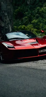 Red sports car speeding down a mountain road.