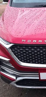 Front view of a red SUV with rain droplets on the hood.