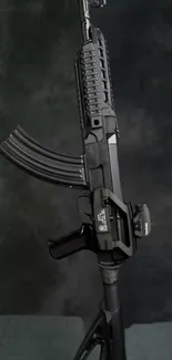 Sleek black rifle on a dark background wallpaper.