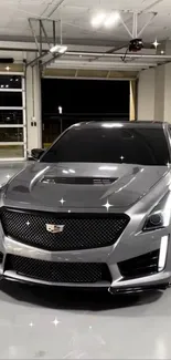 Sleek silver luxury car parked in a modern garage.